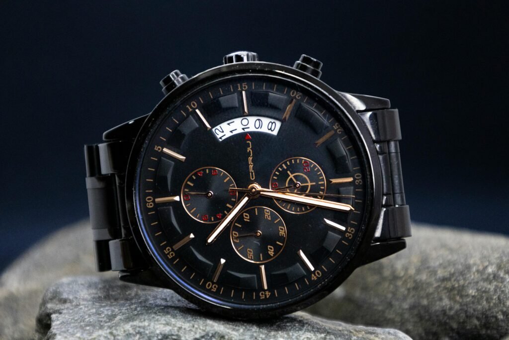 Close-up of a stylish black chronograph wristwatch showcasing its intricate dial design.
