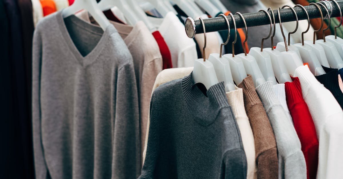 A collection of colorful clothing on racks in a retail store setting.